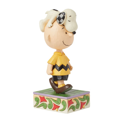 Snoopy on Charlie Brown's Head